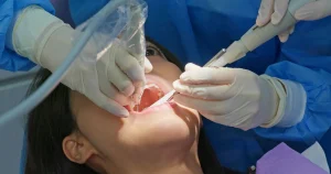 Dentist disinfecting root canal with sterilized instruments in a clean, hygienic operatory at Bright Smile Dental Clinic, Khurrianwala, Faisalabad